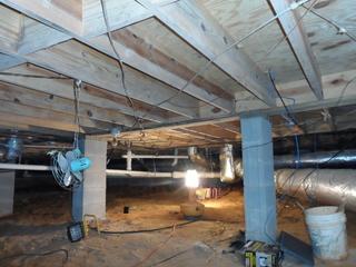 This is the crawlspace once our crew has removed the insulation. It looks a lot neater, but the best part hasn't been installed just yet.