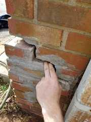 As the foundation settled the corner of the exterior wall cracked to release the pressure.