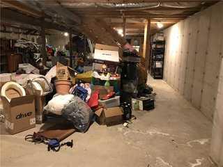 Here you can see what the basement was being used before any finishing was done. It is clearly just a storage space but could be so much more with proper finishing and utilization.