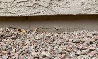 A close up of the cracked concrete stem wall before the stem wall repair was made.