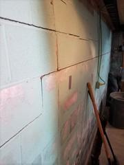 Moisture and pressure from the ground started to shift this foundation wall.