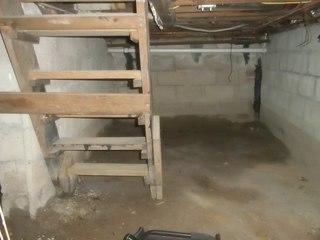 This crawl space has a wet dirt floor, not the ideal place for storage.