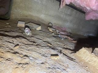 Photo of random debris underneath crawl space that will need to be cleaned before clean space installation.