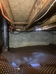 This dimpled drainage matting system is designed to collect the water from a crawl space floor to redirect it to a pump and drainage pipe.