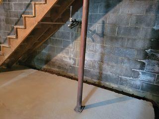 This photo shows after the crew dug the trench around the perimeter. They clean the broken cement out of the area to make room for the Water Guard.