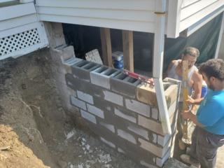 Our team is working hard to finish this foundation wall.