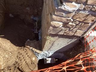 The completed installation of two Helical piers before the hole is filled and and the ground leveled out.