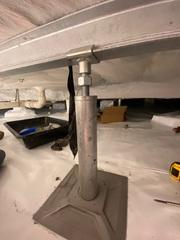 SmartJack system being installed. These heavy-duty steel posts are adjusted to offer permanent stability.