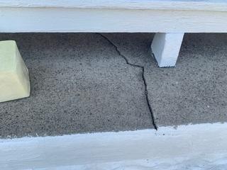 The left side of this porch was sinking and seperating from the right side. You can tell because in this crack, the left side of the crack sits lower than the right.