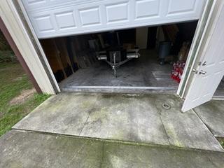 The concrete pad just outside the detached garage continued to have mold and mildew buildup due to poor grading. The water would pool up on the pad and remain for too long.