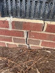 This was on the exterior part of the home near the front entrance and staircase. This is a deep crack that even goes through the brick itself - a clear indication that some heavy shifting and settling has occurred to this home's foundation.