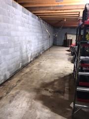 These garage walls were damaged from water seeping through the cinder blocks.
