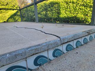 The cracks to this pool deck were causing damage to the tiles and tripping hazards all around. This homeowner called LRE Foundation Repair to figure out the solution to his growing problem.