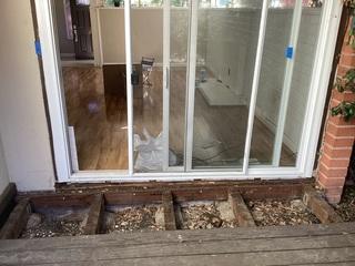 The foundation had sunk, causing this sliding glass door to be a pain to open.