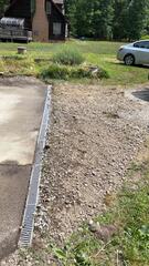 To prevent the driveway from flooding or having standing pools of water, our crew installed this TrenchDrain system. Its unique and durable design won't ever crack or dent. Clogging is not worry as the grated cover can be easily removed to clean and clear the drainage channel.