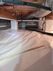 This crawl space was humid, wet, and musty, but not anymore! Our ultra-durable CleanSpace is made from a 20-mil thick polyethylene composition. Once installed, it covers, seals, and protects the crawl space from moisture and humidity - providing a bright, dry, and healthy look and feel.