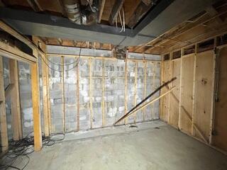 The white chalky residue on the walls is a result of water seeping through the block wall.