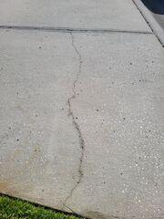 Cracks in the concrete can be a result of soil settlement below. Not only are concrete cracks unsightly, but they can also allow moisture to penetrate below the concrete and cause even more soil to wash away.
