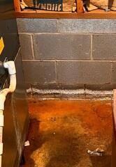 These white chalky lines are evidence of water that has come through the block wall and then dried up leaving mineral residue behind.