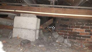The settling soil under the home has caused the block piers to sink, creating a lack of proper support for the floor joists above.