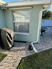 Before the installation of the new drainage system, the back porch of the home had encountered flooding issues. The original downspout from the gutters above had directed a substantial amount of rainwater around the foundation below.