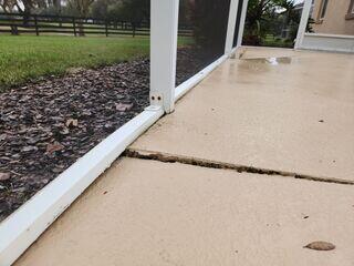 The homeowner's pool deck has experienced damage brought on by soil settlement, resulting in the development of cracks and trip hazards in the concrete.