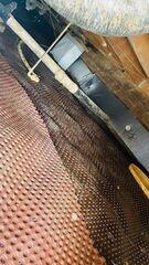 The CleanSpace drainage matting is laid out along the ground of the crawl space. Its dimpled design prevents water from pooling around the foundation underneath the vapor barrier.