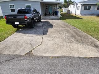 The homeowner's driveway had endured years of wear and tear, resulting in discoloration and numerous cracks across the surface. Additionally, the concrete slabs had become uneven due to the soil settling beneath them.