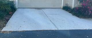 Over time, the homeowner's driveway has developed increasingly severe cracks and settled, not only becoming unsightly but also posing a safety hazard.