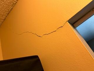 Interior wall cracks extending from the corners of door frames is a very common symptom of foundation settlement issues.