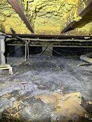 Without proper moisture regulation, the crawl space beneath this home suffered from water damage caused by rainstorms, which could lead to structural issues and mold growth.