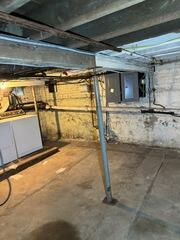 This basement needed new supports in the basement because its floor was sagging above.