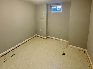Old flooring is removed in the basement for a WaterGuard System and Elite Thermal Plank flooring to be installed.