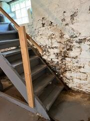 The water intrusions have peeled away the paint on the walls.