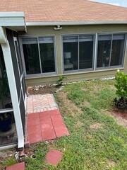 The homeowner reported severe flooding around this area of their home and expressed concerns about its impact on the foundation. Erosion of the soil around the base of the foundation highlighted the severity of the problem.