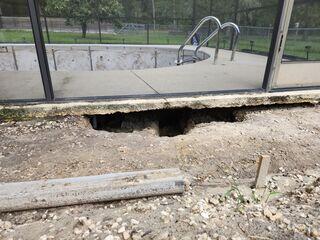 The erosion of soil beneath the pool deck had resulted in a substantial void, causing instability in the deck and affecting its overall structure.