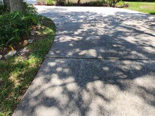 Soil settlement had caused the concrete slabs in the homeowner's driveway to sink and become uneven, creating significant tripping hazards and the potential for injuries.