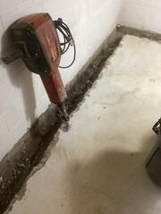 A trench is carefully created around the basement perimeter. WaterGuard and crushed stone are set. Any water entering the home will flow directly into the trench and be pumped out keeping the basement dry.