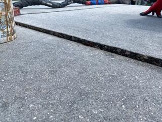 Soil erosion beneath the homeowner's driveway had caused the concrete slabs to settle, creating an uneven surface and posing a significant trip hazard.
