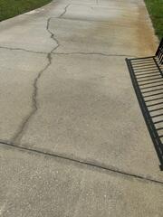 The homeowner became concerned after noticing more and more cracks spreading across the surface of their concrete driveway.