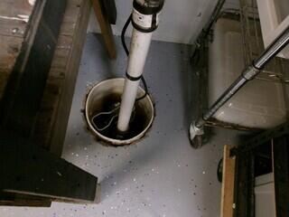 This old sump pump system, installed via a bucket, offered minimal protection against basement moisture.