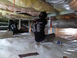 Our foreman is tightening the system to secure the system to ensure its level and in place to stabilize and level the floor above.
