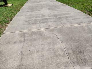 The homeowner's concrete driveway had settled and cracked as a result of the underlying soil becoming unstable over time.