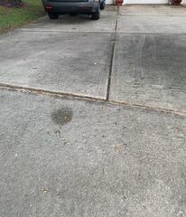 Soil settlement had caused the concrete slabs of the homeowner's driveway to become uneven, resulting in multiple tripping hazards