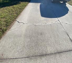 Numerous cracks had formed in the homeowner's concrete driveway along with many tripping hazards due to the settlement of the underlying soil.