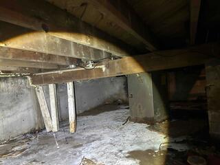 This crawlspace had old supports that needed replacing tin order to stabilize the home above.