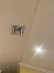Cracks along the ceiling inside the home were an alarming sight for the homeowner, raising concerns about their foundation's stability.