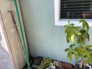 Large exterior wall cracks emanating from the home's window frames were a clear indication to the homeowner that their foundation's stability may have been compromised.