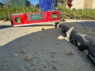 This section of the homeowner's concrete driveway had settled significantly, creating a problematic tripping hazard.