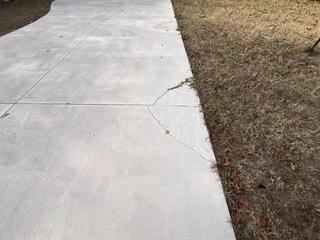 This section of the homeowner's concrete driveway had cracked and sunk due to the settlement of the underlying soil.